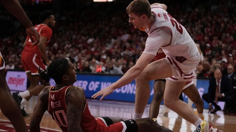 Wisconsin's Steven Crowl fouls Maryland's Julian Reese during the second...