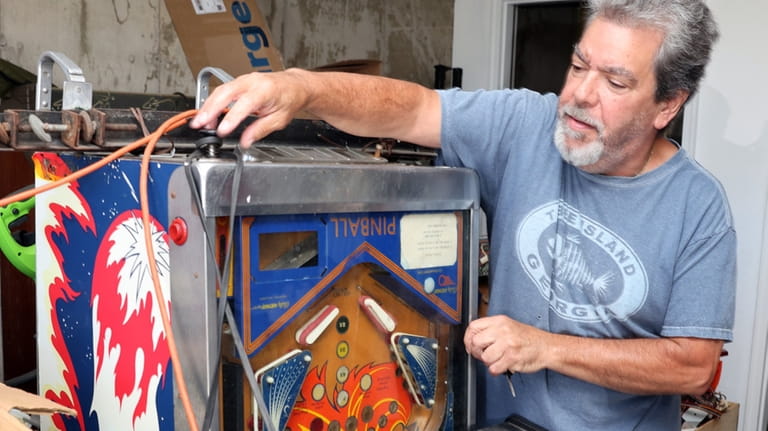 Danny D'Elia with a pinball machine from the early 1980s.