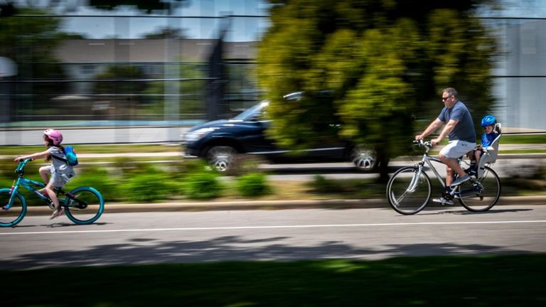 People running, walking and biking through John J. Burns Park...