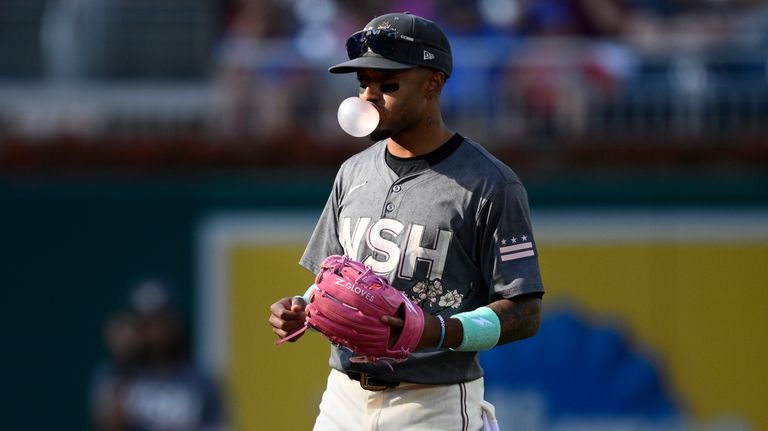 Washington Nationals shortstop Nasim Nunez blows a bubble as he...