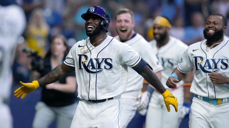 Brandon Lowe of the Tampa Bay Rays celebrates with teammates Randy