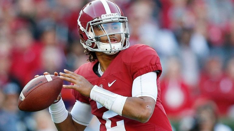 Alabama quarterback Jalen Hurts sets back to pass during the...