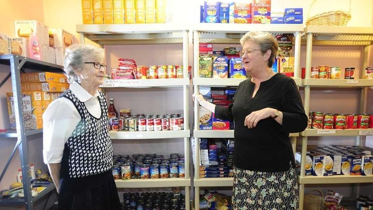 Left to right: Volunteer Patricia Rosalia talks with Sister Christine...