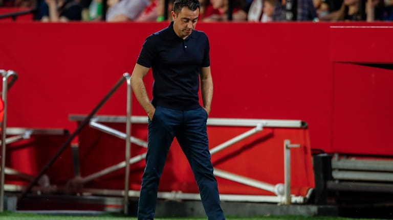 Barcelona's head coach Xavi Hernandez looks down during a Spanish...