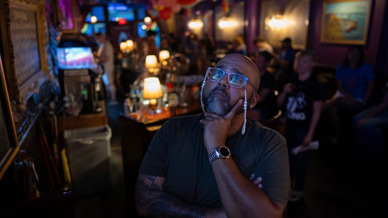 Jacardo Ralston, 47, from Pennsylvania, looks up to a television...