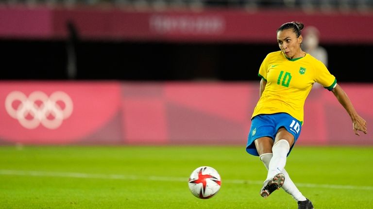 Brazil's Marta kicks in a penalty shootout during a women's...