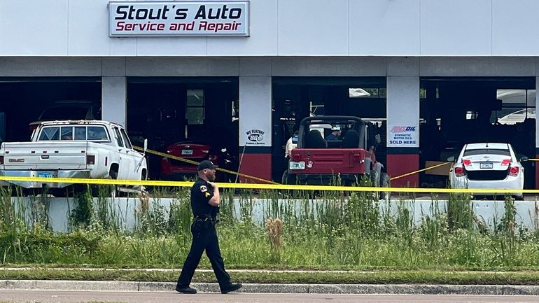 Law enforcement investigate the scene of a shooting, Sept. 27,...