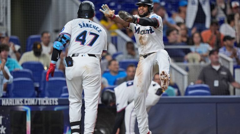 Miami Marlins' Ali Sánchez (47) congratulates Otto Lopez after Lopez...