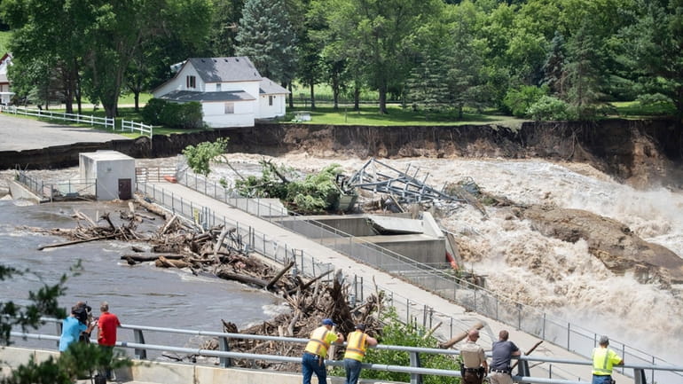 Onlookers take in the catastrophic damage to the Rapidan Dam...