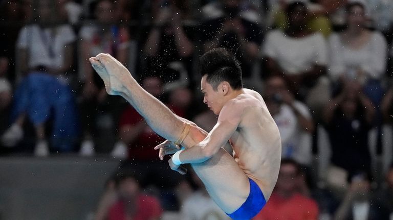 China's Cao Yuan competes in the men's 10m platform diving...