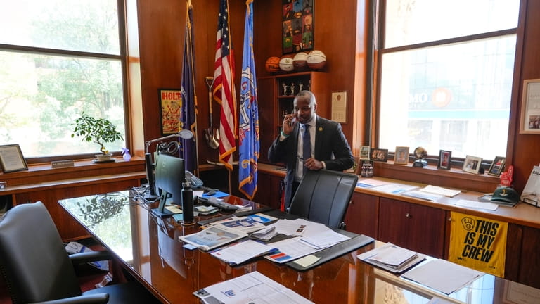 Milwaukee Mayor Cavalier Johnson talks on his phone after an...