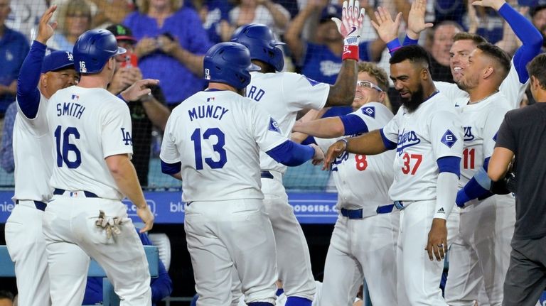 Los Angeles Dodgers Jason Heyward, back center, is congratulated by...