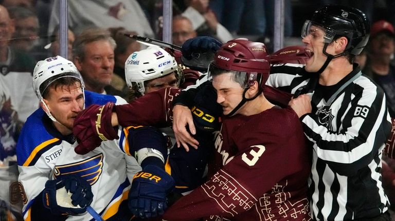 Linesman Joe Mahon (89) tries to break up a scuffle...