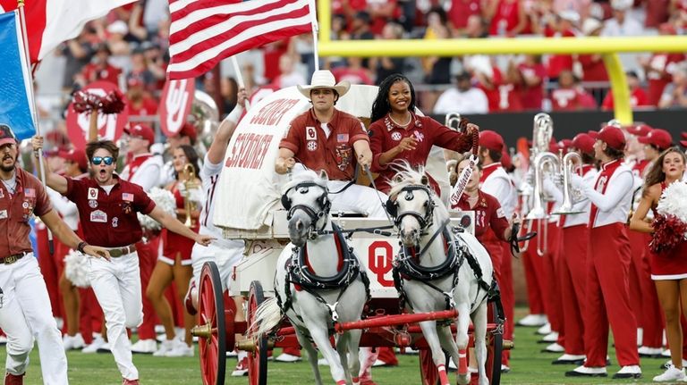 The Oklahoma Sooner Schooner runs out onto the field ahead...