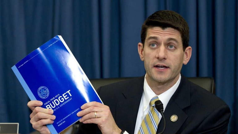 House Budget Committee Chairman Rep. Paul Ryan, R-Wis., holds up...