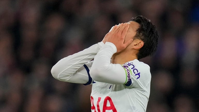 Tottenham's Son Heung-min reacts after missing a chance to score...