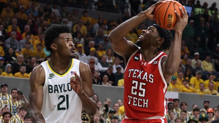 Texas Tech forward Robert Jennings attempts a shot over Baylor...