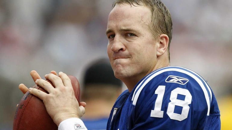Quarterback Peyton Manning of the Indianapolis Colt warms up before...