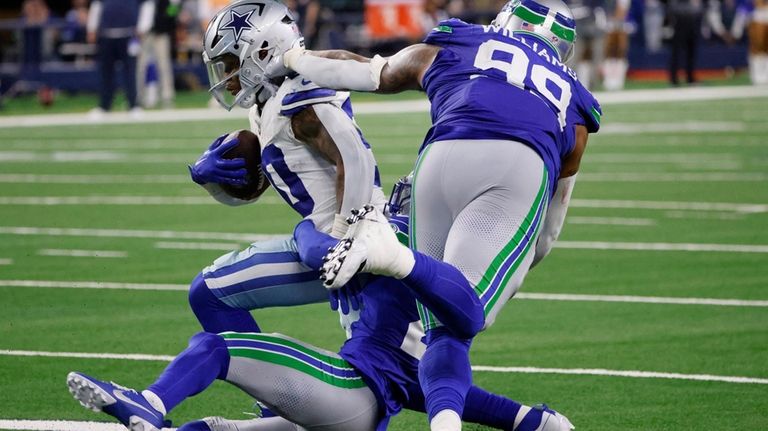 Dallas Cowboys running back Tony Pollard, top left, runs the...