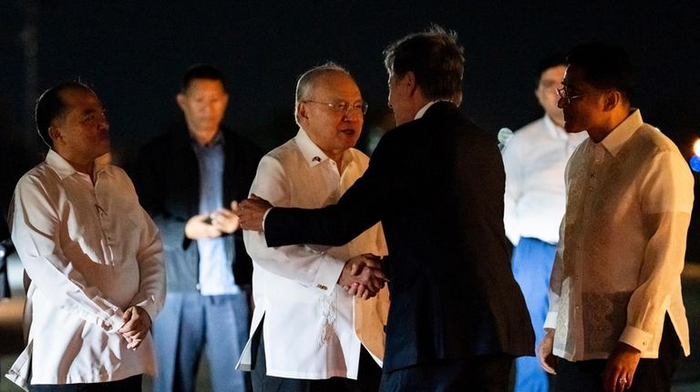 U.S. Secretary of State Antony Blinken is greeted by Philippine...