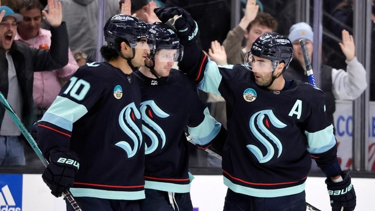 Seattle Kraken right wing Jordan Eberle, right, celebrates his goal...