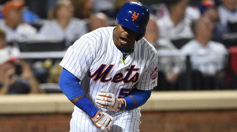 New York Mets leftfielder Yoenis Cespedes tosses his bat after...
