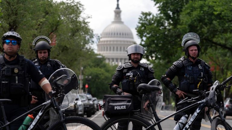 U.S. Capitol police watch demonstrators marching outside of the U.S....