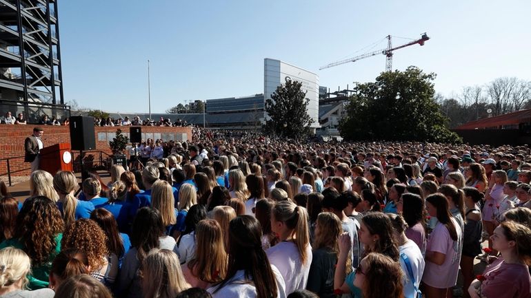 A crowd of people gather to mourn the loss of...