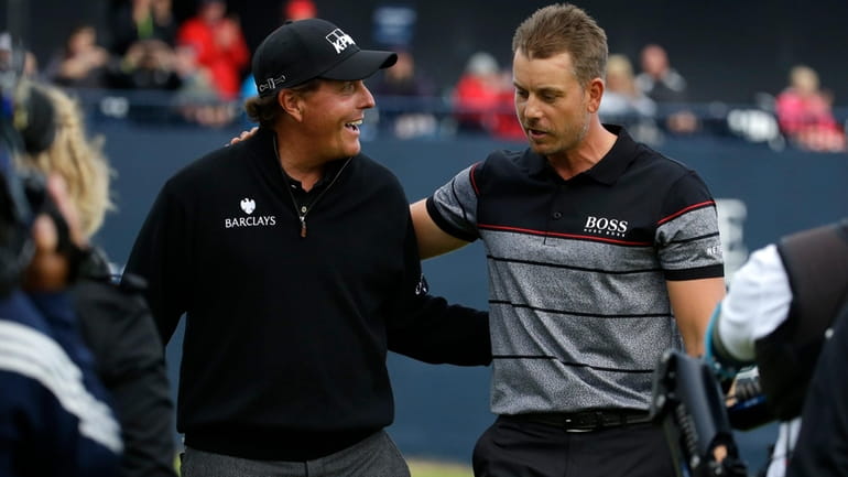 Phil Mickelson of the United States, left, congratulates Henrik Stenson...