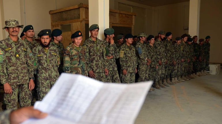 Afghanistan National Army (ANA) soldiers are briefed at Forward Operating...
