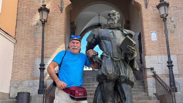 Rory Sadoff poses next to a statue of Don Quixote...