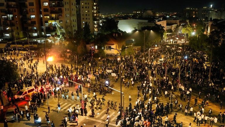 Ultra-Orthodox Jewish men clash with police during a protest against...