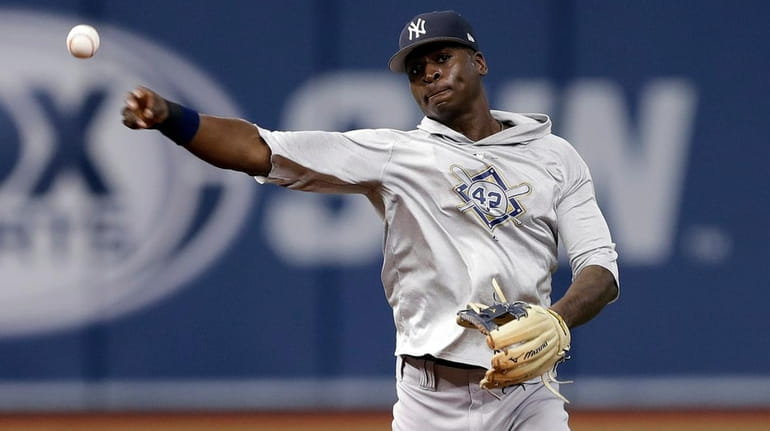 Yankees shortstop Didi Gregorius throws the ball to first base...