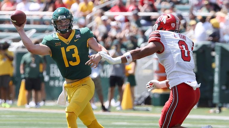 Baylor quarterback Sawyer Robertson throws on the run as Utah...