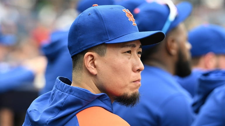 Mets pitcher Kodai Senga looks on from the dugout against the...