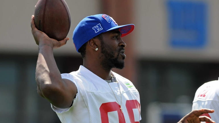 Giants wide receiver Hakeem Nicks throws a ball a teammate...