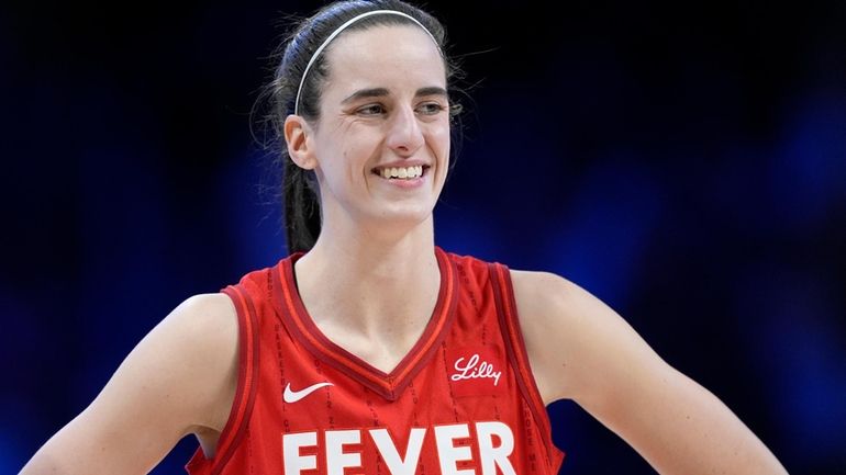 Indiana Fever's Caitlin Clark (22) smiles as she talks with...