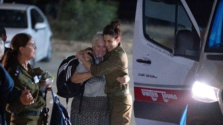 Margalit Mozes, a released Israeli hostage, walks with an Israeli...