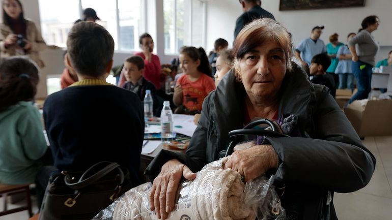 Ethnic Armenians from Nagorno-Karabakh gather as they wait to receive...