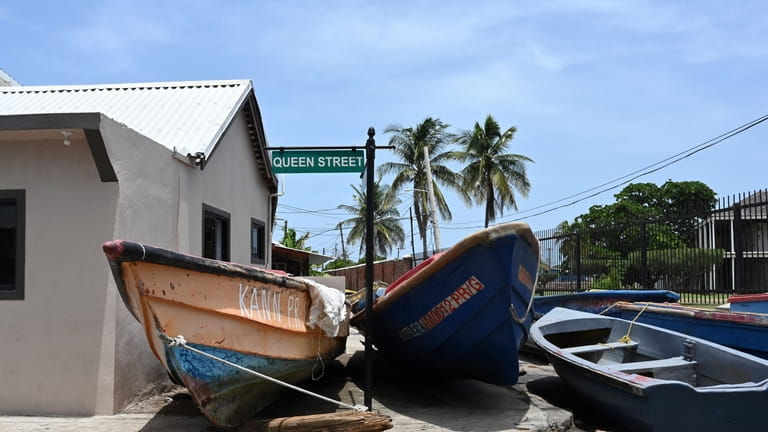 Fishing boats lie in the middle of the street for...