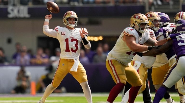 San Francisco 49ers quarterback Brock Purdy (13) fumbles the ball...