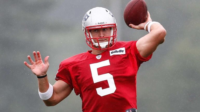 Tim Tebow throws during the first day of New England...