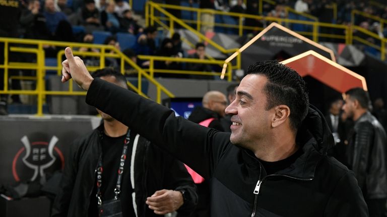 Barcelona's head coach Xavi Hernandez greets fans before the Spanish...