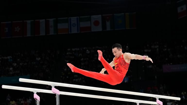 Zou Jingyuan, of China, competes during the men's artistic gymnastics...