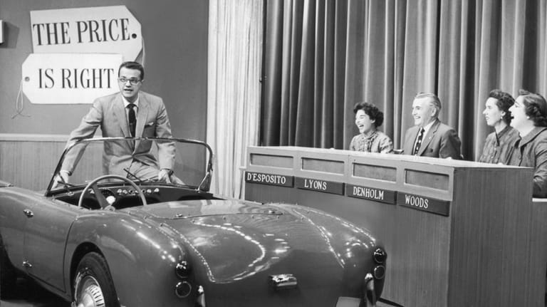 Bill Cullen sits on the edge of a convertible sports...