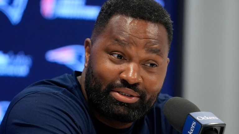 New England Patriots head coach Jerod Mayo faces reporters during...