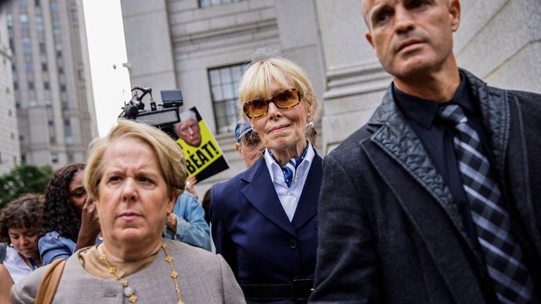 E. Jean Carroll, center, leaves federal court in Manhattan with...