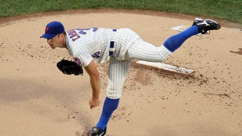 Chris Capuano #38 of the New York Mets pitches against...