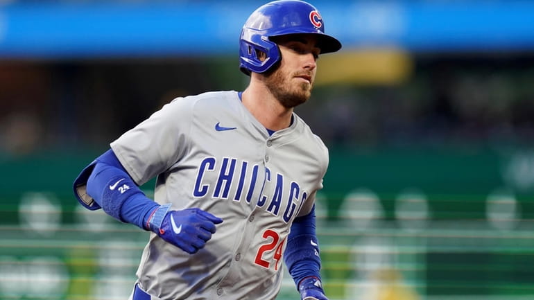 Chicago Cubs' Cody Bellinger rounds the bases after hitting a...
