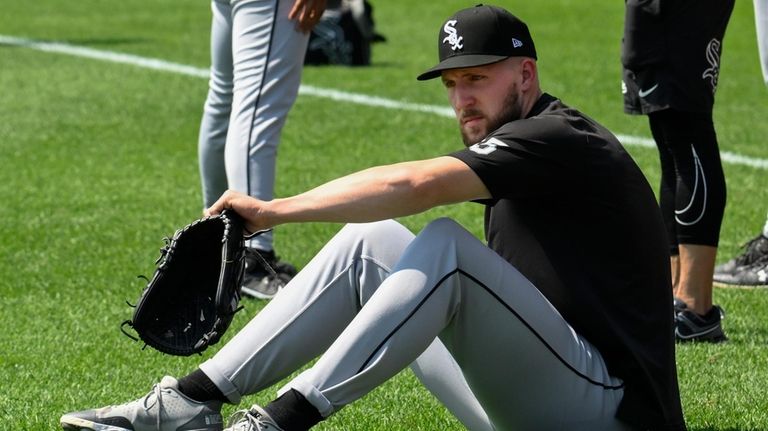 The White Sox's Garrett Crochet gets up after stretches before...